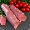 Raw pork fillet with parsley and tomatoes.